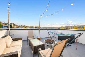 a patio with chairs and a hammock on a balcony at Modern & Cozy New Townhome; Heart of Fremont in Seattle