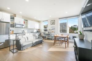 a kitchen and living room with a couch and a table at Modern & Cozy New Townhome; Heart of Fremont in Seattle