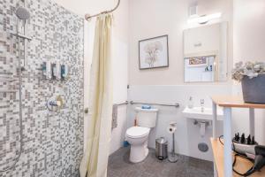 a bathroom with a shower and a toilet and a sink at Cozy & Private Studio in the Heart of Fremont in Seattle
