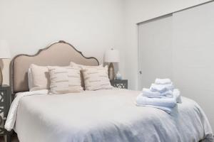 a bedroom with a white bed with towels on it at The Canal 15A BY Betterstay in Seattle