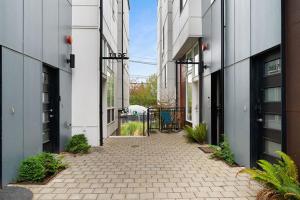 a brick walkway between two tall buildings at The Canal 15A BY Betterstay in Seattle