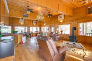 a living room with wood paneled walls and a ceiling at Salmon Vacation Rental with Mountain Views! in Salmon