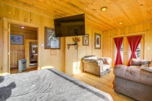 a bedroom with a bed and a flat screen tv at Salmon Vacation Rental with Mountain Views! in Salmon