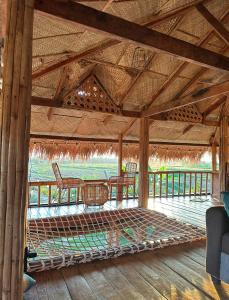 a patio with a table and chairs in a pavilion at Joseph Agricultural Farm in Ubay