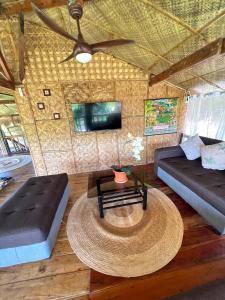 a living room with a couch and a table at Joseph Agricultural Farm in Ubay