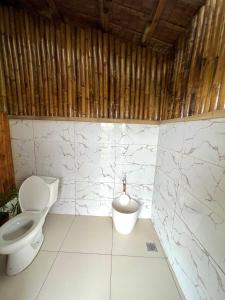 a bathroom with a toilet and a bidet at Joseph Agricultural Farm in Ubay