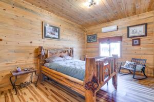 a bedroom with a bed in a log cabin at Salmon Vacation Rental with On-Site River Access! in Salmon