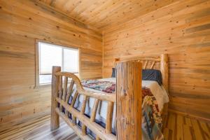 a bedroom with a bed in a log cabin at Salmon Vacation Rental with On-Site River Access! in Salmon