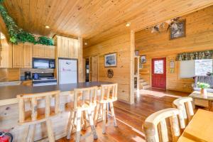 a kitchen and dining room of a log cabin at Pet-Friendly Idaho Home on the Salmon River! in Salmon