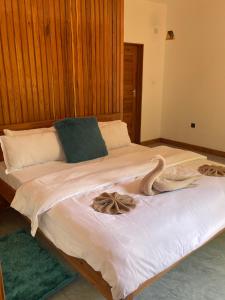 a bedroom with a large bed with towels on it at CosyBe Villas in Inhambane