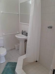 Baño blanco con aseo y lavamanos en Apt 1 Lynsted - Newly renovated 2 bed 1 bath, en Bridgetown