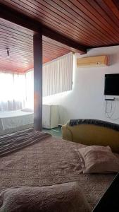 Säng eller sängar i ett rum på Pousada Canto da Praia