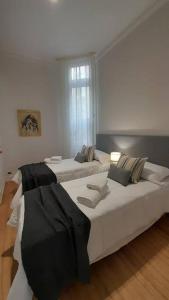 a bedroom with two beds and a window at Baires Art Decó in Buenos Aires