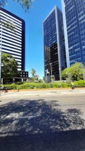 a shadow of a fire hydrant in front of tall buildings at Baires Art Decó in Buenos Aires