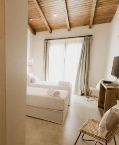 um quarto com uma cama e uma grande janela em Hotel Boutique Miss Olivos em São Rafael