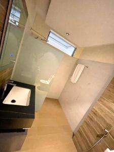a bathroom with a sink and a window at Contemporary Suite in Kibuye
