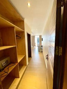 a hallway of a room with wooden shelves and a floor at Contemporary Suite in Kibuye