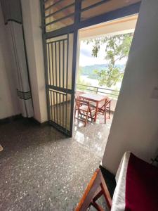 a room with a table and a balcony with a view at Contemporary Suite in Kibuye