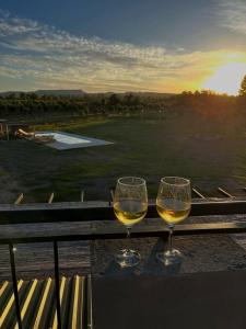 two glasses of wine sitting on a table with a view at Posada Miss Olivos in San Rafael