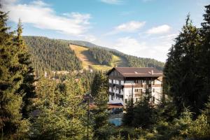 a large building in the middle of a forest at Pensiunea Panoramic in Vartop
