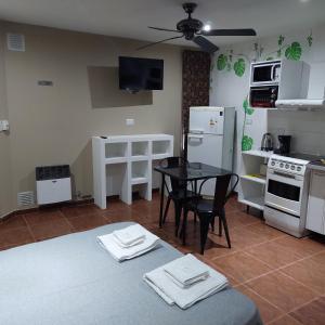 a kitchen with a table and a small table with chairs at Hotel Segundo Roma in Villa La Paz