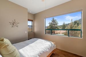 a bedroom with a bed and a large window at Great Sedona Home Sensational Views! in Sedona