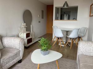 a living room with a couch and a table at Departamento Río Valdivia in Valdivia