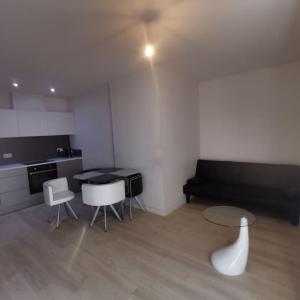 a living room with a couch and a table and chairs at 1 Bed Apartment in Cardiff Bay -Dixie Buildings in Cardiff