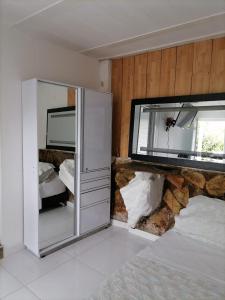 a bedroom with a bed and a mirror on the wall at Finca Mirador la Giralda in Roldanillo +27 photos