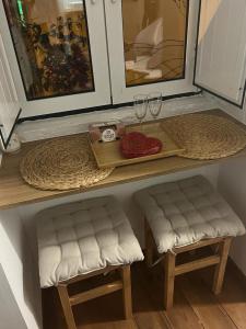 a table with two chairs and wine glasses on it at Alfama authentic Lisbon in Lisbon