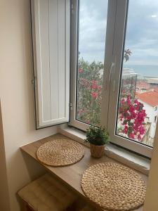 a window with two straw hats on a table in front of a window at Alfama authentic Lisbon in Lisbon