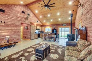 a living room with a couch and a dining room at Rural Drexel Cabin on 30 Acres Unplug and Unwind! in Drexel