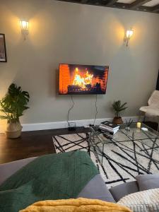 a living room with a fire on the wall at Stylish Apartment in CENTRAL LONDON in London