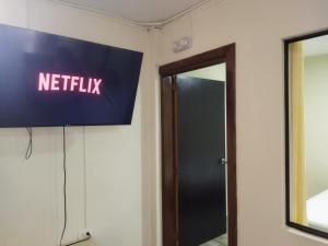 a sign that says netflix on a wall next to a door at Canto del rio in Jardin