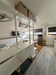 a room with white shelves and a living room at Casa Amanda in Sestriere