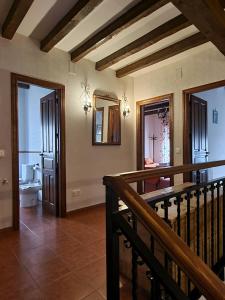 a large room with a staircase and a bathroom at Casas Rurales TIO CLAUDIO I y II in El Barraco