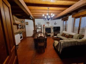 a living room with a couch and a table at Casas Rurales TIO CLAUDIO I y II in El Barraco