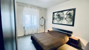 a bedroom with a bed in a room with a window at Miraflowers Home in Turin