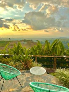 a group of chairs and tables on a patio at La Puesta Del Sol in Filandia