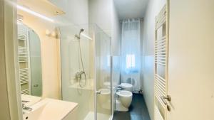 a bathroom with a shower and a toilet and a sink at Miraflowers Home in Turin +11 photos