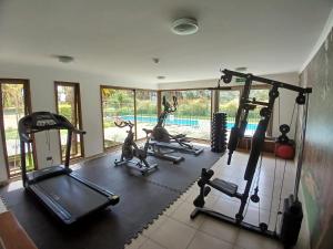 a gym with treadmills and exercise bikes in a room at Costa Algarrobo Norte in Algarrobo