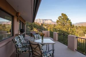 balcón con mesa, sillas y montañas en Open Style Home with Magnificent Views!, en Sedona