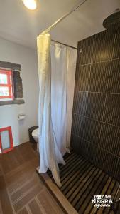 a bathroom with a shower with a shower curtain at Welcome to Paradise in Angra do Heroísmo