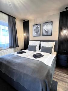 a bedroom with a large bed with two towels on it at The Steakhouse - Guest Rooms in Sankt Johann im Pongau