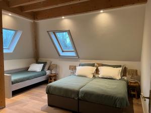 a bedroom with two beds and two windows at Inn Het Nest in Amsterdam