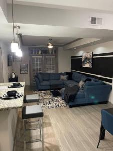 a living room with a blue couch and a table at Downtown Atlanta in Atlanta