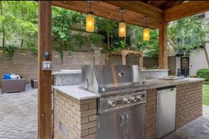 an outdoor kitchen with a grill on a patio at Downtown Atlanta in Atlanta