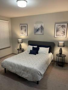 a bedroom with a bed with two lamps on two tables at Modern Luxury Fully Furnished 2BRM & 2Bath Downtown Atlanta Apartment in Atlanta