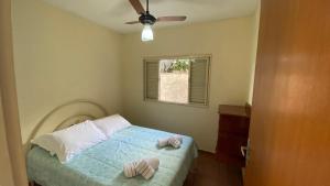 a bedroom with a bed with two pillows on it at Casa com varanda, 2 quartos, wi-fi, próximo ao centro da cidade in Ribeirão Preto