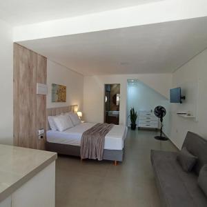 a bedroom with a bed and a living room at Ap 01 apartamento Beira mar in Pontal do Paraná